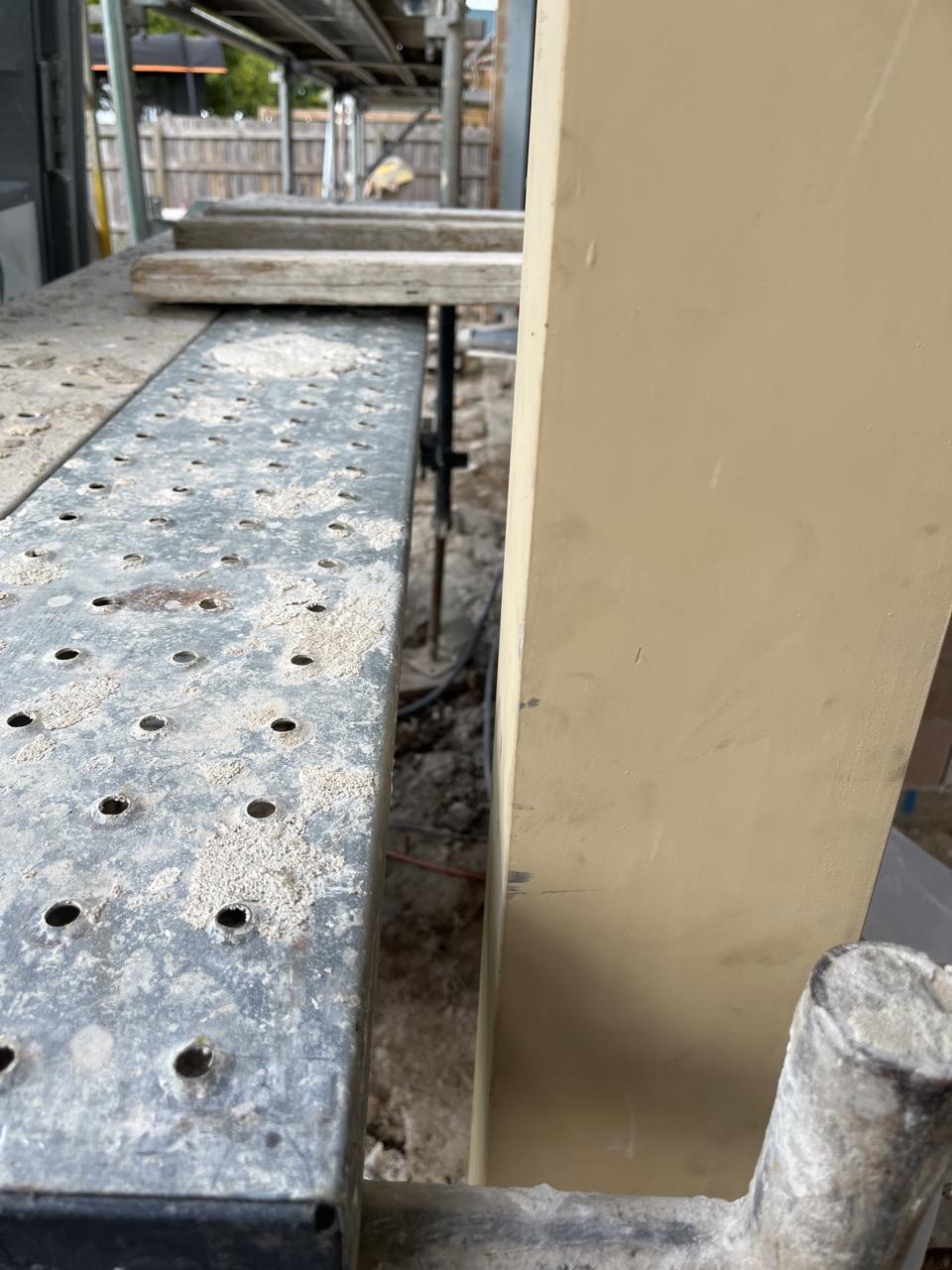 Another companies rafter fallguard still installed and scaffold in way